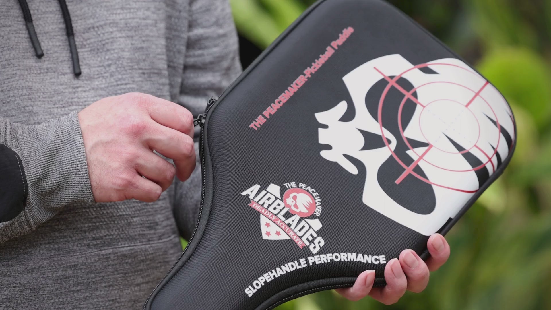 Video showing the AirBlades Peacemaker Pickleball Paddle being taken out of its protective hard case, highlighting the smooth edgeless carbon fibre design and the patented SlopeHandle grip engineered for comfort and control.